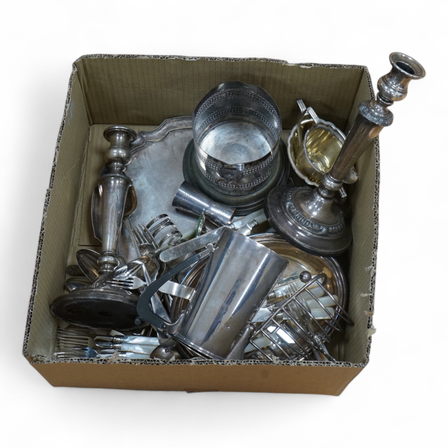 A group of assorted plated ware, including a pair of candlesticks, a salver, toast rack and cutlery including set of mother of pearl handled dessert eaters, together with a George V silver mounted trinket box and two sil